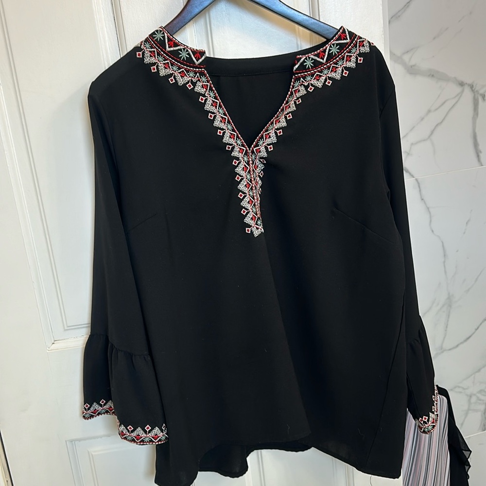 I’m 54 and the blouse comes right to my hip